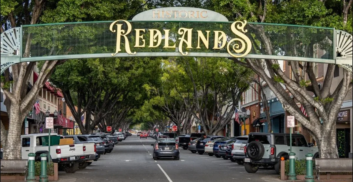 Historic Redlands archway over a tree-lined downtown street in Redlands, CA