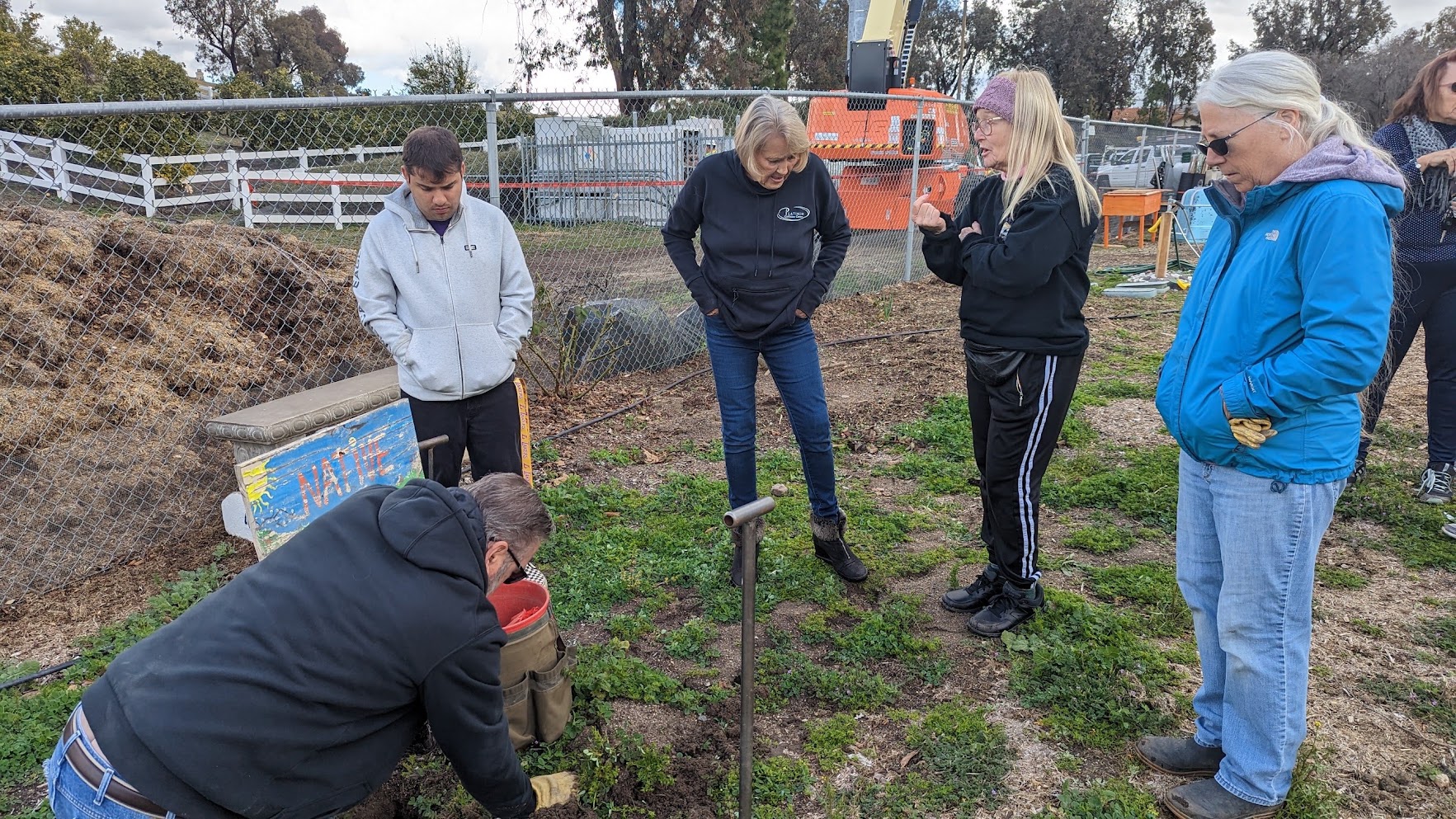The Gopher Stop team working with a customer in their garden, a real service moment